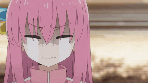 a close up of a girl with pink hair making an angry face