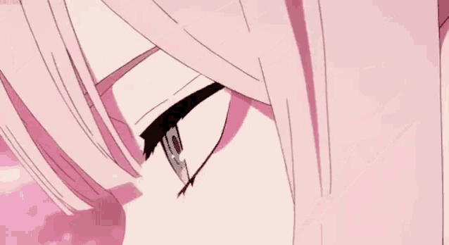 a close up of a person 's eye with a pink background .