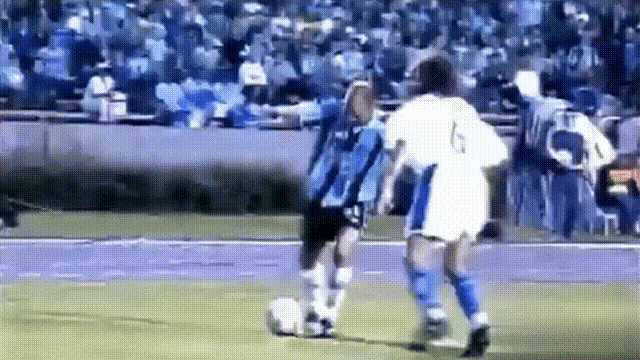 a soccer player with the number 6 on his jersey is kicking a soccer ball