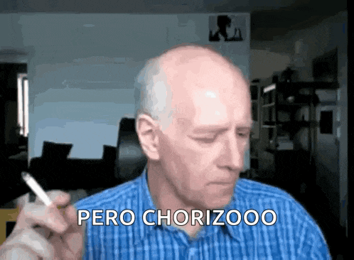 a man in a blue plaid shirt is smoking a cigarette and saying pero chorizooo .