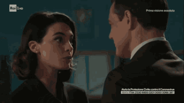 a man and a woman are looking at each other on a television screen that says rai 1 hd