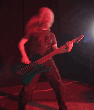 a man in a black shirt is playing a blue bass guitar