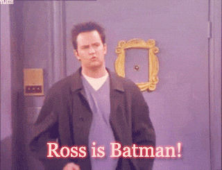 a man standing in front of a door that says " ross is batman " on it