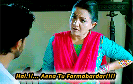 a woman in a pink dress is talking to a man with the words hai !!! aena tu farmabardar !!!