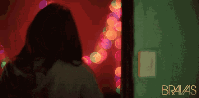 bravas is written on the bottom of a green door