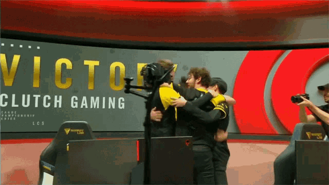 a group of people hugging in front of a sign that says victory