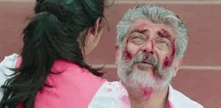 a man with a beard and a woman standing next to him with blood on his face .