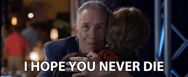 a man hugging a woman with the words " i hope you never die " written below him