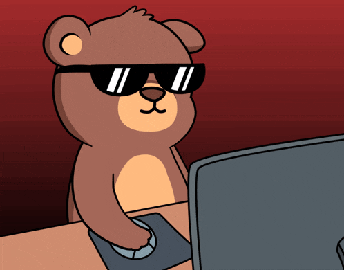 a teddy bear wearing sunglasses is sitting in front of a computer monitor