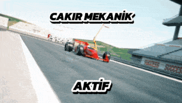 a red race car is on a track with the words cakir mekanik and akif below it