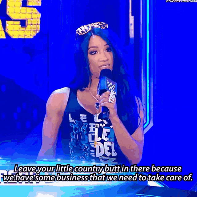 a woman with blue hair is holding a microphone and says leave your little country but in there because