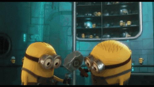 a couple of minions standing next to each other holding a hammer