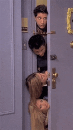 a group of people peeking out of a doorway