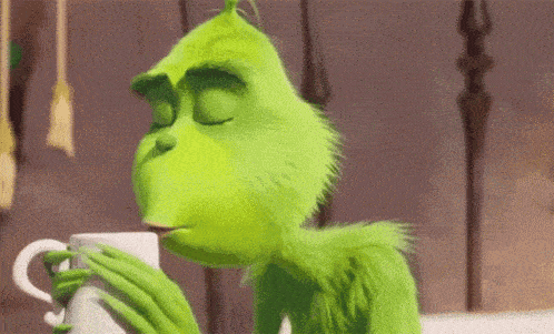 the grinch from the movie the grinch is drinking from a cup .