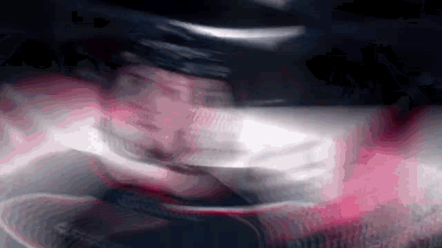 a blurry picture of a person wearing a black helmet