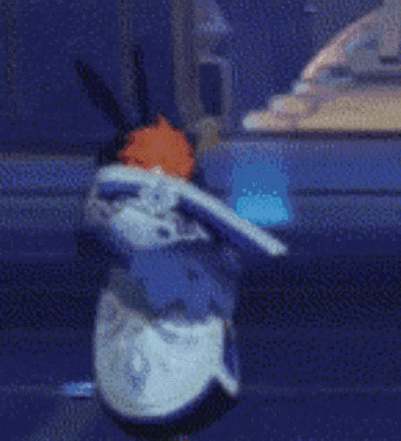 a cartoon character is sitting on a blue couch .