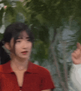 a woman in a red shirt has a circle of white dots on her head