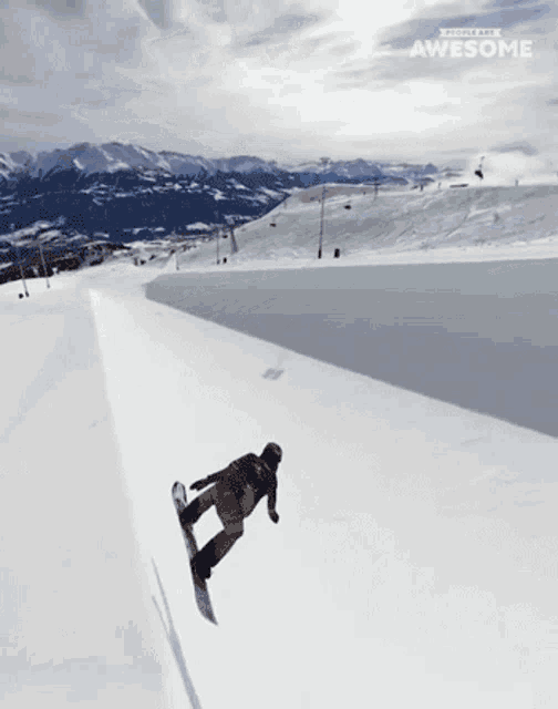 a snowboarder is doing a trick on top of a snow covered slope and the words awesome are on the bottom of the screen