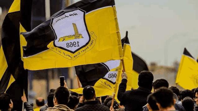 a crowd of people are holding up yellow and black flags with the letters eaei on them .