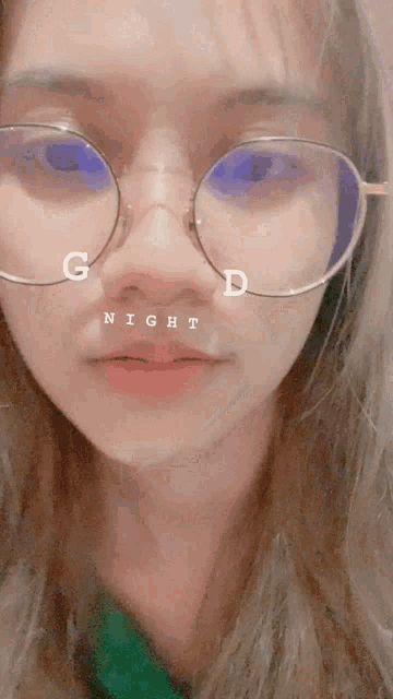 a woman wearing glasses says good night