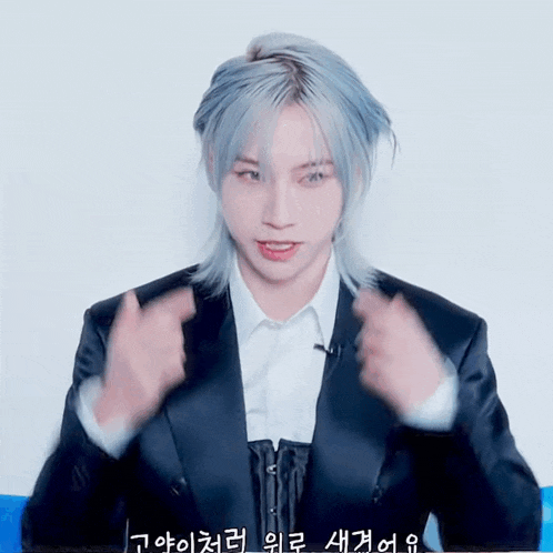 a man with long blue hair is wearing a suit and a white shirt