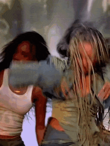 two women are fighting with each other and one has long blonde hair