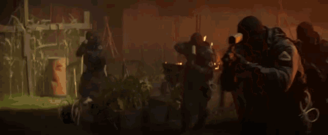 a group of men are standing in a dark room holding guns .