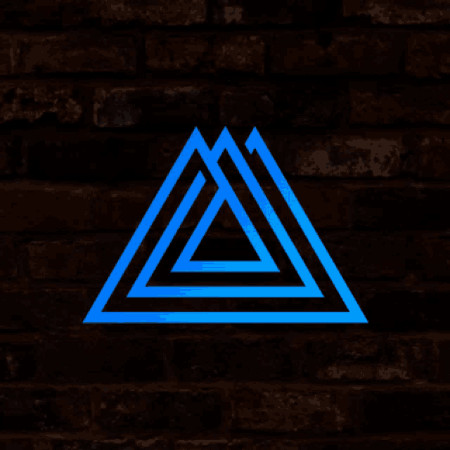 a dark brick wall with a blue triangle in the foreground