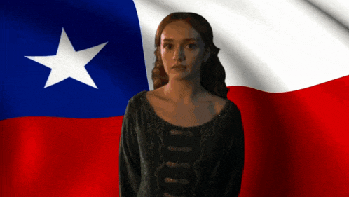 a woman stands in front of a flag with a white star on it