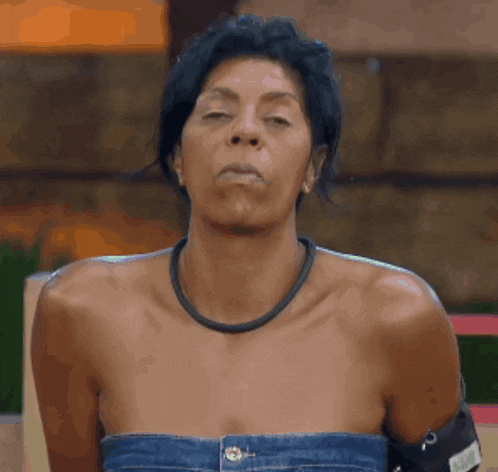 a woman without a shirt is making a funny face with her mouth open
