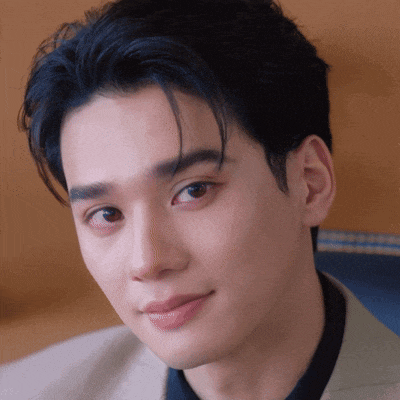 a close up of a young man 's face with a slight smile on his face