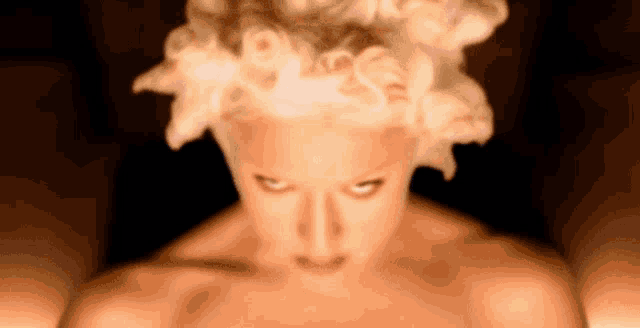 a woman without a shirt is looking at the camera