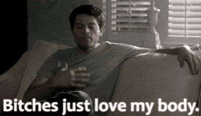 a man is sitting on a couch with the words " bitches just love my body " below him