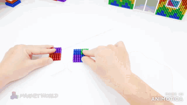 a person is playing with a rainbow colored puzzle made by magnet world