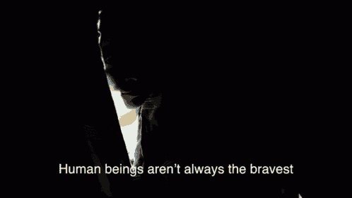 a man in a dark room with the words " human beings aren 't always the bravest " below him