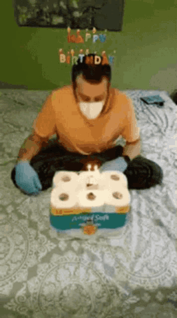 a man wearing a mask and gloves is celebrating his birthday with toilet paper