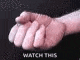 a close up of a person 's fist with the words `` watch this '' written on it .