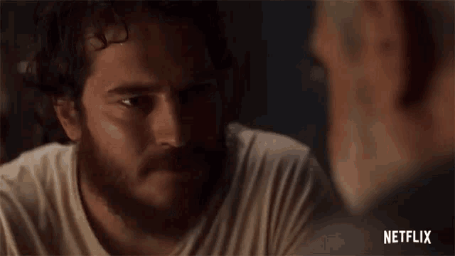 a man with a beard is talking to another man and says `` i 'll take care of this kid then netflix ''