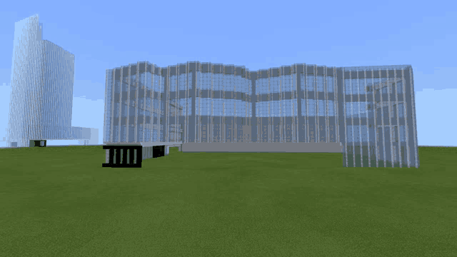 a large building with a lot of windows is surrounded by grass