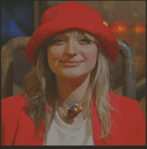 a woman wearing a red hat and a white shirt