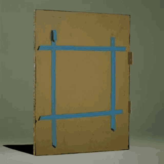 a piece of cardboard has blue tape on it