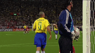 a soccer player wearing a yellow jersey with the number 9 on it
