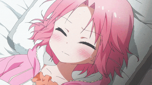 a girl with pink hair laying on a bed with her eyes closed