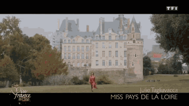 miss france julie tagliavacca is walking in front of a castle