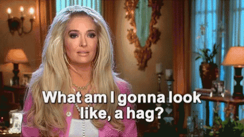 a woman in a pink jacket is asking what am i gonna look like a hag
