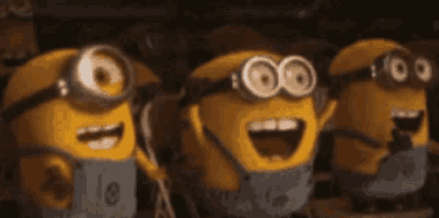 three minions wearing goggles and masks are standing next to each other