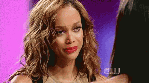 a woman is crying while looking at another woman .