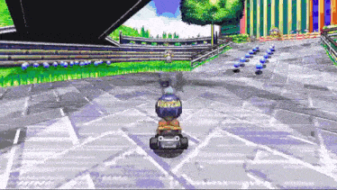 a cartoon character is riding a kart on a track .