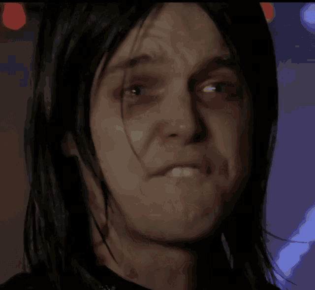 a close up of a person 's face with bloody eyes