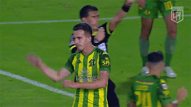 a soccer player wearing a green and yellow striped jersey with the number 21 on it